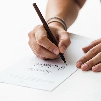 Close-up of a person signing a petition, symbolizing ballot access signature collection in Maryland