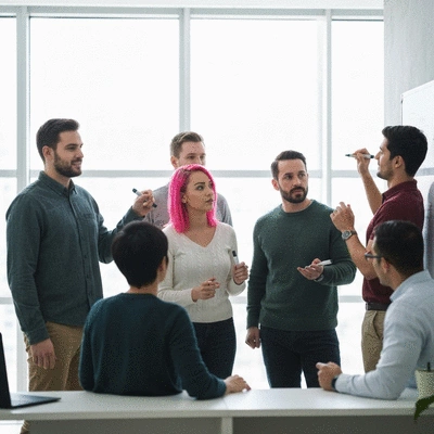 Diverse group of campaign team members collaborating on a large whiteboard, brainstorming campaign messages and strategy, clean image