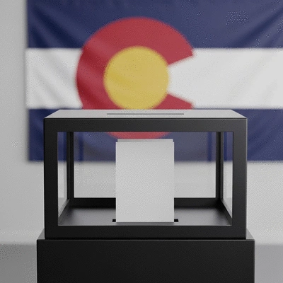 Modern election ballot box with Colorado flag in background, clean image